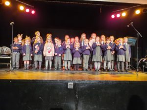Primary School children on stage singing