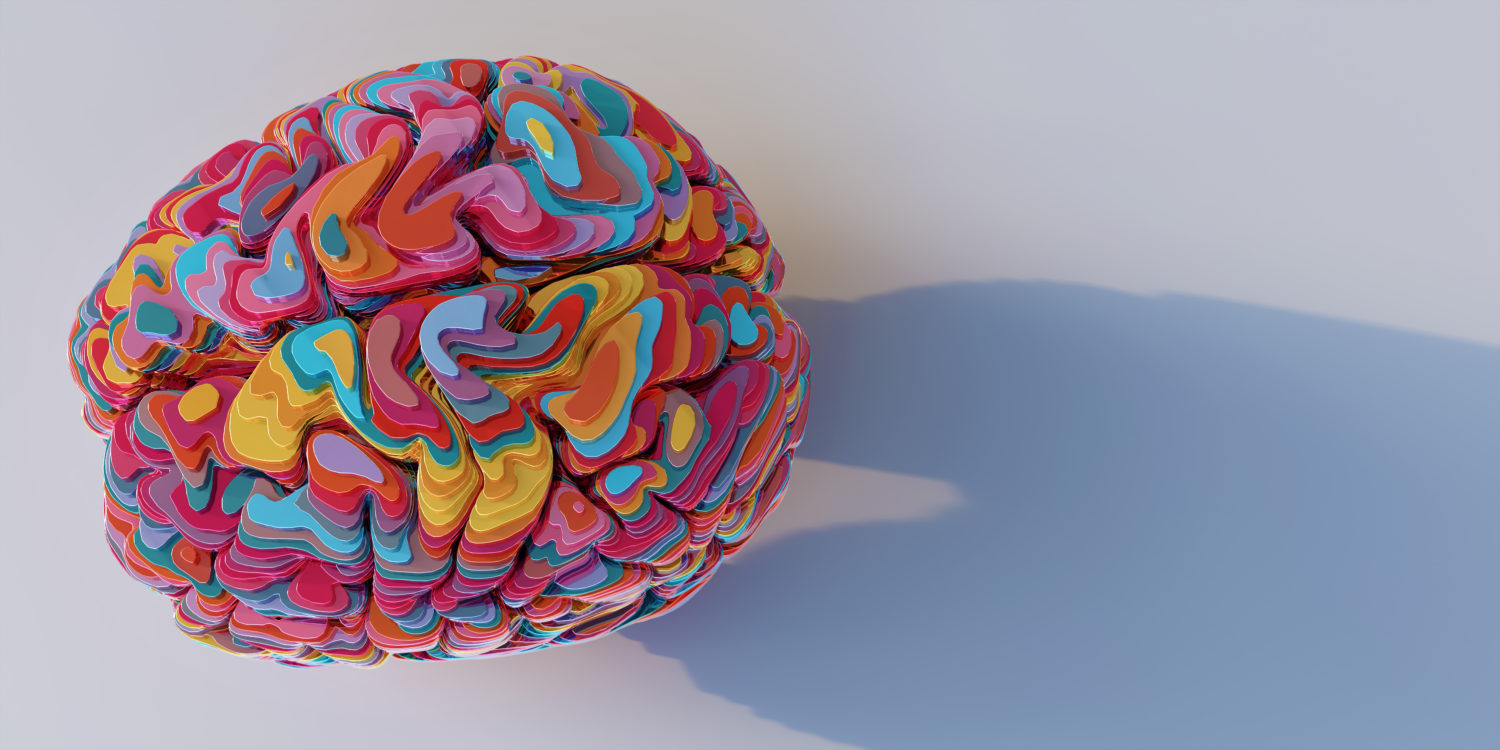 Model Of A Brain Made From Many Multi-Coloured Metallic Sliced Layers Stacked On Top Of Each Other