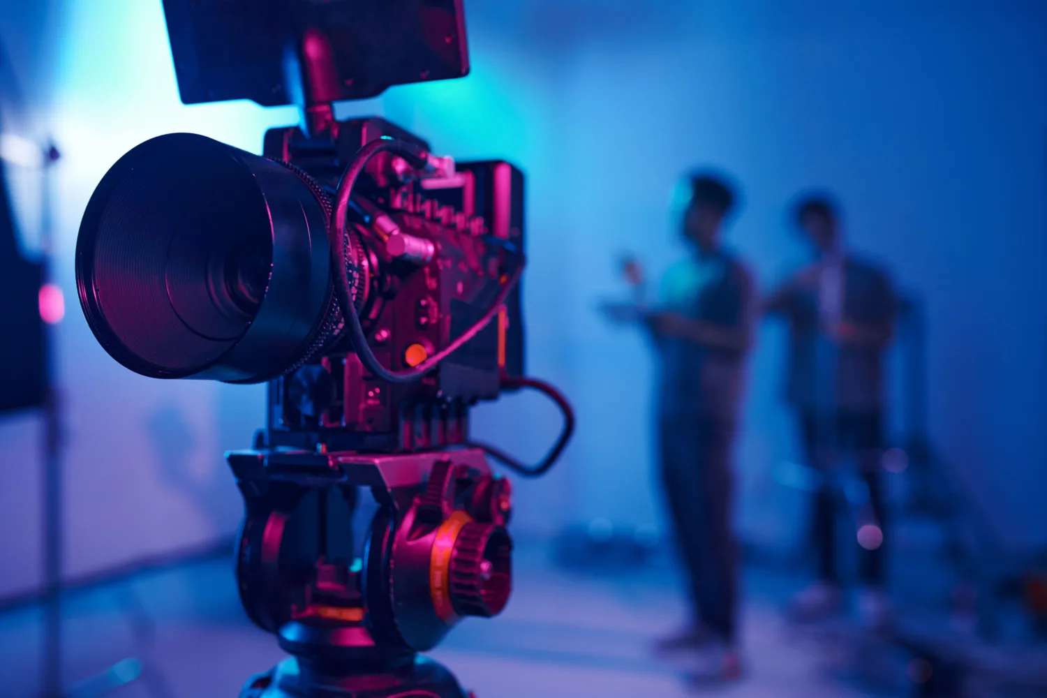 Close-up of professional camera for professional shooting with camera crew in background
