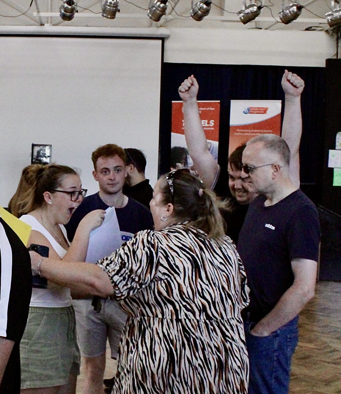 Post-16 students are pictured smiling along with their parents, after having just opened their A-Level results.