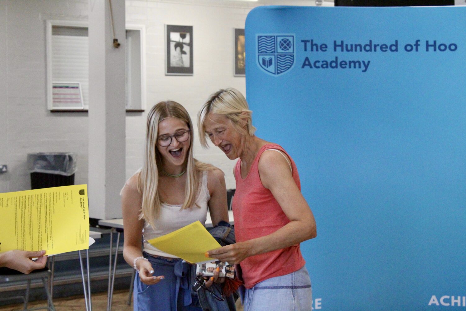 A female Post-16 student is pictured smiling with joy beside her mother, after having just opened her A-Level results.